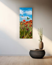A sunlit meadow of red poppies and purple grape-hyacinth spikes with orange and green butterflies against a bright blue, cloud-dappled sky. panoramic glass wall art A