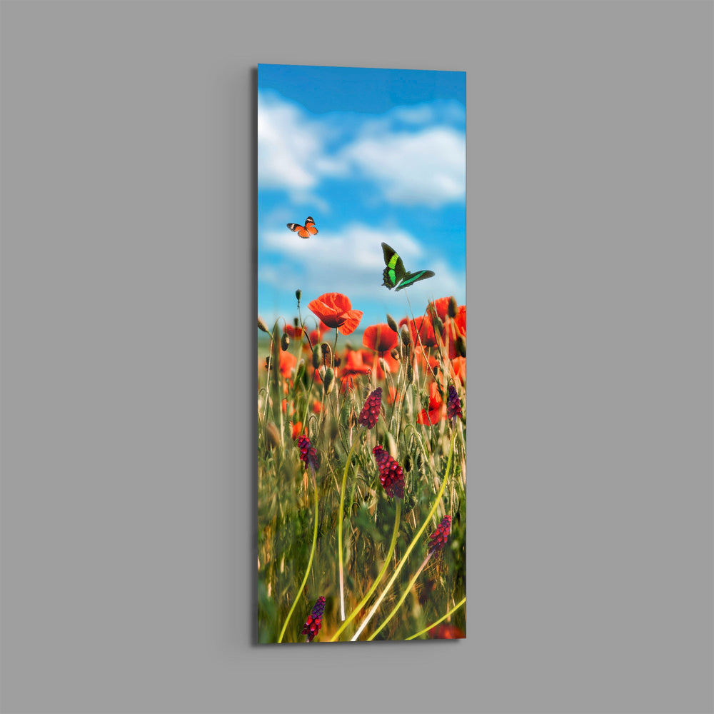 A sunlit meadow of red poppies and purple grape-hyacinth spikes with orange and green butterflies against a bright blue, cloud-dappled sky. panoramic glass wall art E
