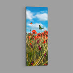 A sunlit meadow of red poppies and purple grape-hyacinth spikes with orange and green butterflies against a bright blue, cloud-dappled sky. panoramic glass wall art E