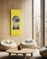 A black-and-white human eye peering out through a keyhole-shaped cutout in a flat, bright-yellow surface. panoramic glass wall art C