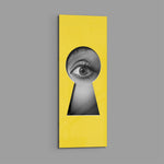 A black-and-white human eye peering out through a keyhole-shaped cutout in a flat, bright-yellow surface. panoramic glass wall art E