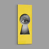 A black-and-white human eye peering out through a keyhole-shaped cutout in a flat, bright-yellow surface. panoramic glass wall art E