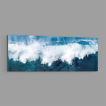 A powerful ocean wave breaking into white foam and spray against deep teal and blue sea water. panoramic glass wall art E