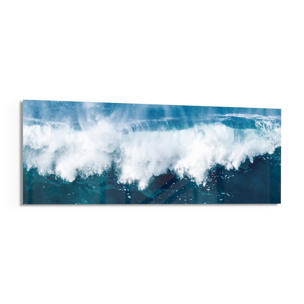 A powerful ocean wave breaking into white foam and spray against deep teal and blue sea water. panoramic glass wall art F