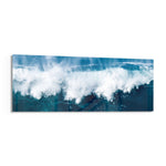 A powerful ocean wave breaking into white foam and spray against deep teal and blue sea water. panoramic glass wall art F