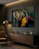 Joker glass wall art displayed above a wood sideboard in a dark living room