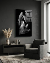 Feather glass wall art displayed above a sideboard in a dark grey living room