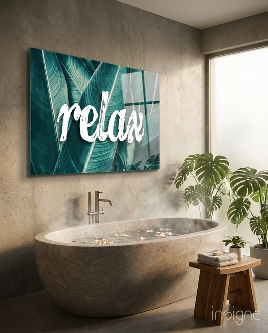 Relax glass wall art displayed above a stone soaking tub in a spa bathroom