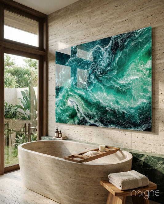 Ocean glass wall art displayed above a stone soaking tub in a coastal bathroom