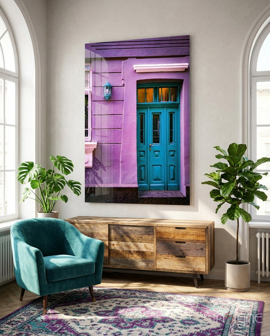 Blue Door glass wall art displayed above a console in a sunlit foyer