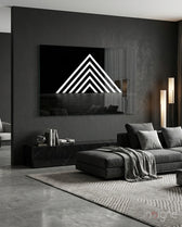 Triangle glass wall art displayed above a marble sideboard in a charcoal living room