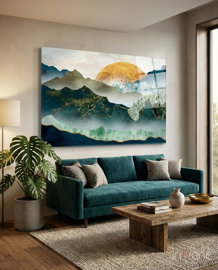 Golden Mountains glass wall art displayed above a teal velvet sofa in a serene living room