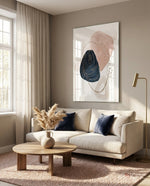 Boho Bloom glass wall art displayed above a cream sofa in a sunlit minimal living room