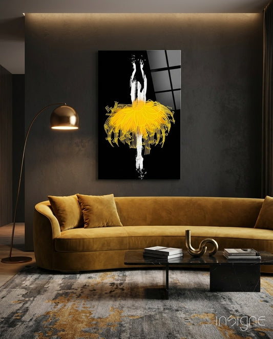 Gold Ballerina glass wall art displayed above an amber sofa in a charcoal-walled lounge