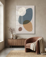 Pebble Stack glass wall art displayed above a wood sideboard in a beige minimal living room