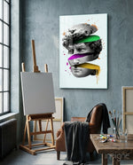 David Slices glass wall art displayed above an easel in a concrete art studio