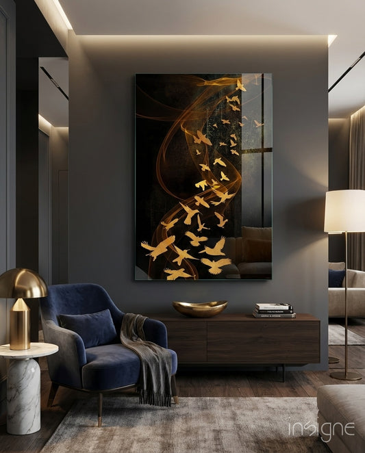 Gold Flight glass wall art displayed above a navy velvet armchair in a charcoal-walled lounge