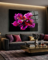 Magenta Bloom glass wall art displayed above a charcoal sectional in a contemporary lounge