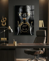 Just Do It glass wall art displayed above a leather chair in a charcoal home office