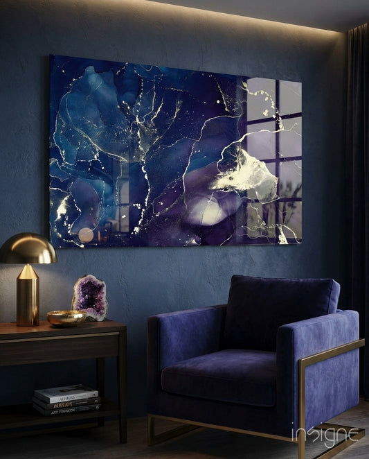 Indigo Marble glass wall art displayed above a navy velvet armchair in a charcoal-walled lounge