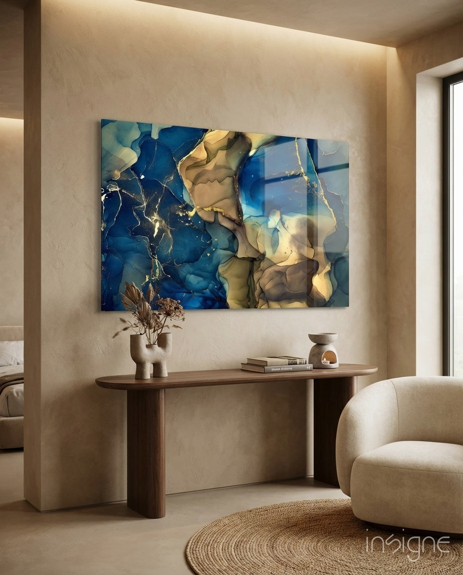 Cobalt Gold Tide glass wall art displayed above a walnut console in a warm beige hallway