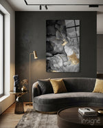 Charcoal Lightning glass wall art displayed above a curved grey velvet sofa in a charcoal-walled lounge