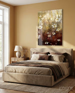 Amber Daisies glass wall art displayed above an upholstered bed in a warm beige bedroom