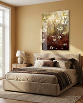 Amber Daisies glass wall art displayed above an upholstered bed in a warm beige bedroom