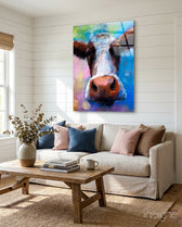 Painted Cow glass wall art displayed above a linen sofa in a shiplap-walled farmhouse living room