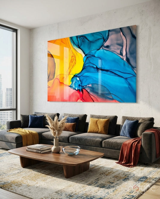 Fire and Tide glass wall art displayed above a charcoal sectional in a white-concrete city-view lounge