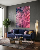 Magenta Bloom glass wall art displayed above a navy velvet sofa in a charcoal-walled lounge