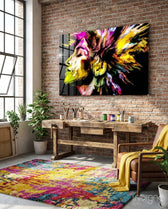 Vivid Mind glass wall art displayed above a wood worktable in an industrial brick artist studio