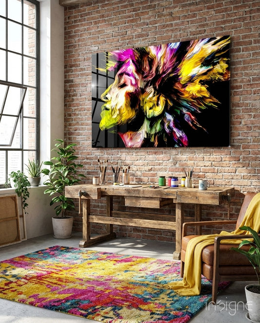 Vivid Mind glass wall art displayed above a wood worktable in an industrial brick artist studio