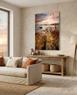 Golden Coast glass wall art displayed above a wood console in a beige minimalist living room with ocean view