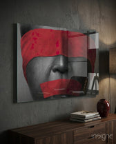 Silenced glass wall art displayed above a walnut credenza in a charcoal-walled lounge