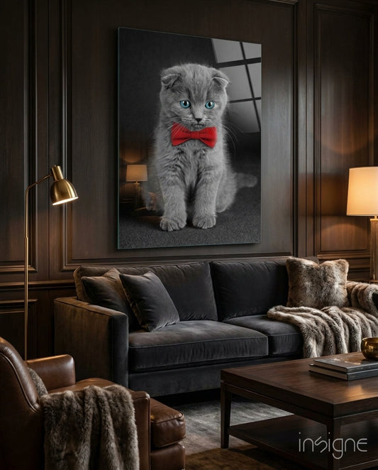 Bow-Tie Kitten glass wall art displayed above a charcoal velvet sofa in a wood-paneled lounge