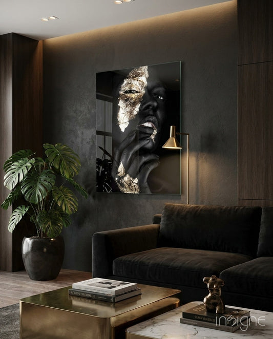 Gilded Gaze glass wall art displayed above a dark velvet sofa in a charcoal wood-paneled lounge