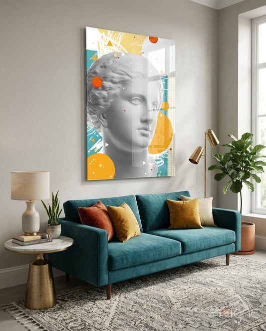 Venus Collage glass wall art displayed above a teal velvet sofa in a bright minimalist lounge