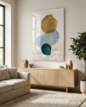 Ochre Stack glass wall art displayed above a wood credenza in a bright minimalist living room
