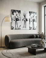 Ballet Triptych glass wall art displayed above a curved bouclé sofa in a warm minimalist living room