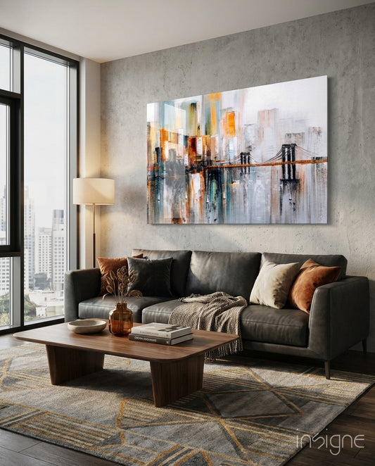 Brooklyn Skyline glass wall art displayed above a charcoal sectional in a concrete city-view lounge