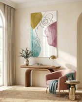 Pastel Drift glass wall art displayed above a wood console in a warm classical entryway with blush armchair