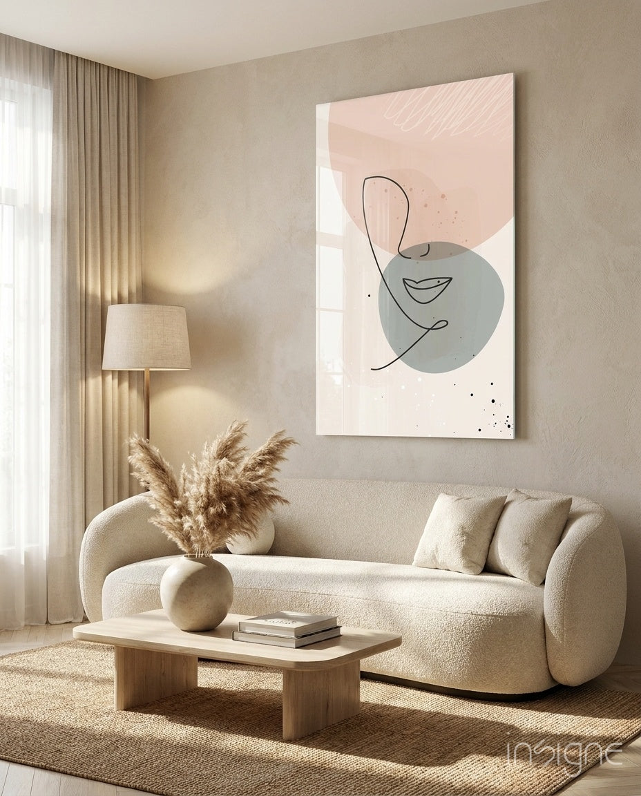 Line Portrait glass wall art displayed above a curved bouclé sofa in a warm minimalist living room