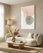 Line Portrait glass wall art displayed above a curved bouclé sofa in a warm minimalist living room