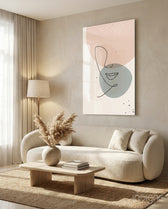 Line Portrait glass wall art displayed above a curved bouclé sofa in a warm minimalist living room