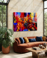 Vivid Iguana glass wall art displayed above a rust velvet sofa in a sandstone tropical conservatory