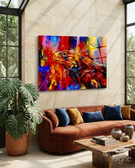 Vivid Iguana glass wall art displayed above a rust velvet sofa in a sandstone tropical conservatory