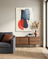 Mid-Century Forms glass wall art displayed above a wood credenza in a warm minimalist living room with charcoal sofa