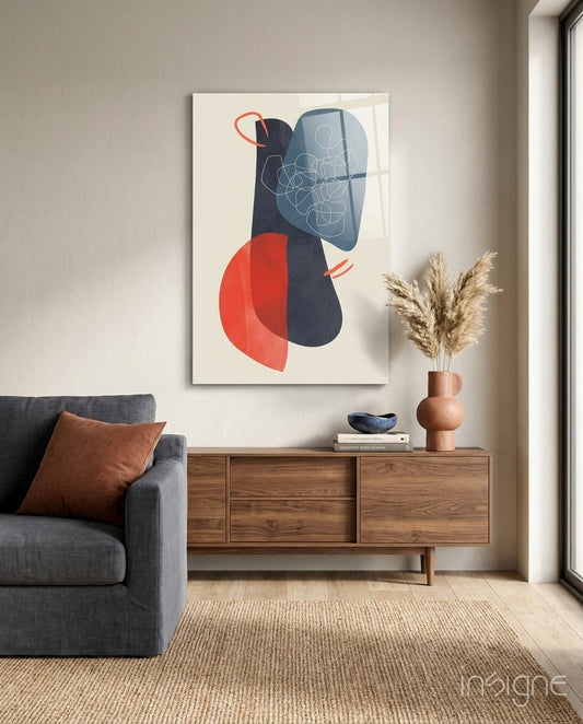 Mid-Century Forms glass wall art displayed above a wood credenza in a warm minimalist living room with charcoal sofa