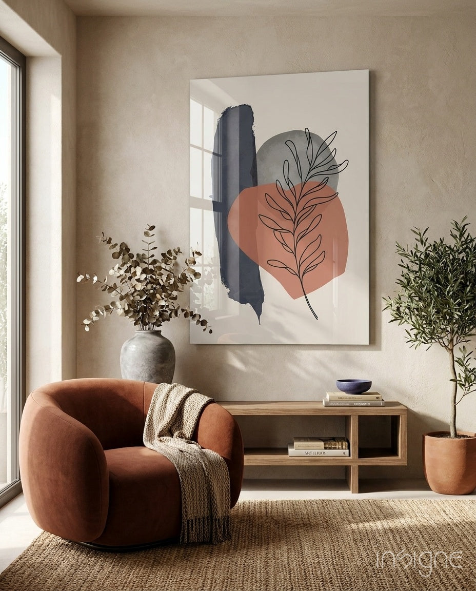 Fern Stack glass wall art displayed above a wood credenza in a warm beige minimalist nook with rust velvet armchair